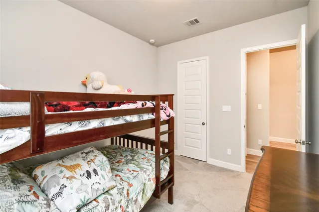 a view of a bedroom with wooden floor