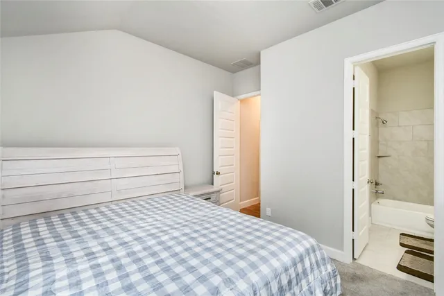 a bedroom with a bed and a couch