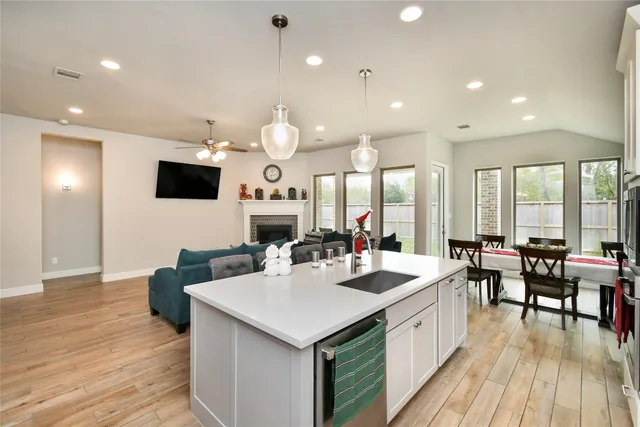 a large kitchen with kitchen island a sink table and chairs