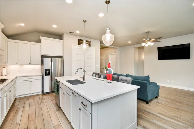 a kitchen with a sink stove and refrigerator