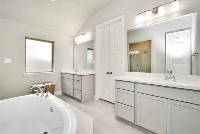 a spacious bathroom with a double vanity sink mirror and