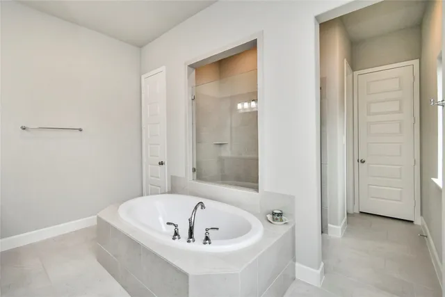 a bathroom with a tub and shower