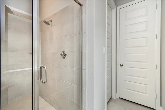 a bathroom with a glass shower door