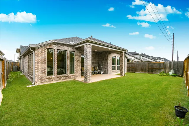 a view of a house with backyard porch and garden