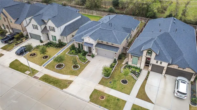 an aerial view of a house with a swimming pool