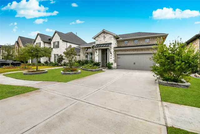 a front view of a house with a yard and staircase
