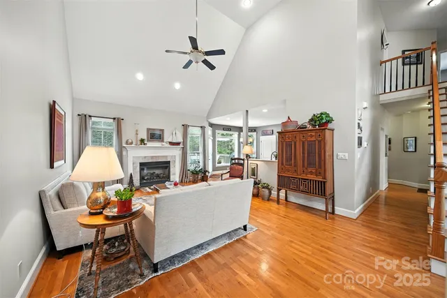 a living room with furniture a fireplace and a chandelier