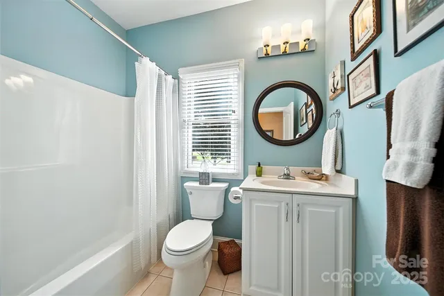 a bathroom with a toilet a sink and a mirror