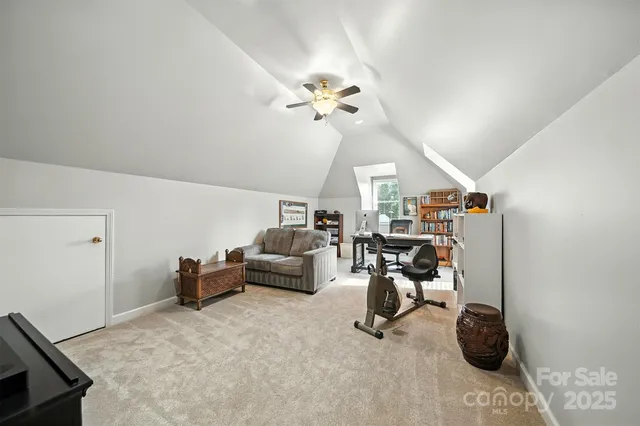 a living room with furniture a chandelier and a rug