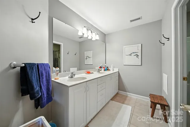 a room with a sink and a mirror