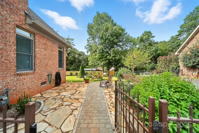 a swimming pool with lots of trees and plants