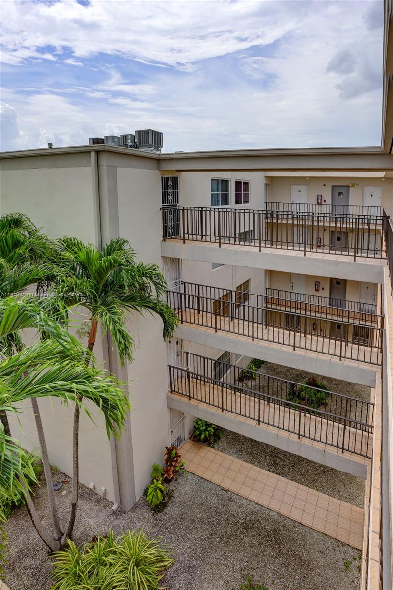 5501 Northwest 7th Street, Unit E408 Miami, FL 33126 - Photo 12 of 35 front view of a house with a yard