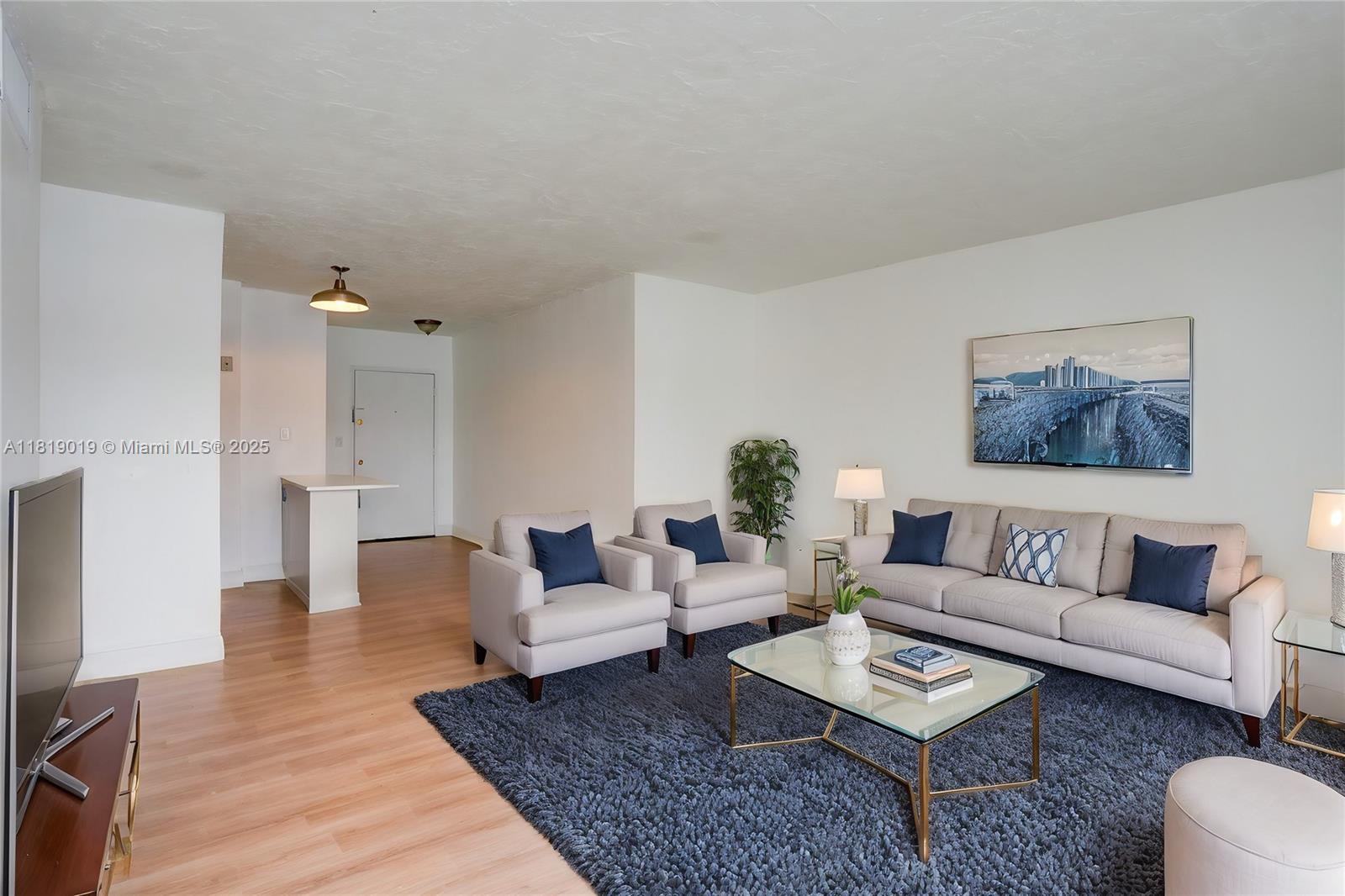 5501 Northwest 7th Street, Unit E408 Miami, FL 33126 - Photo 18 of 35 a living room with furniture and a rug