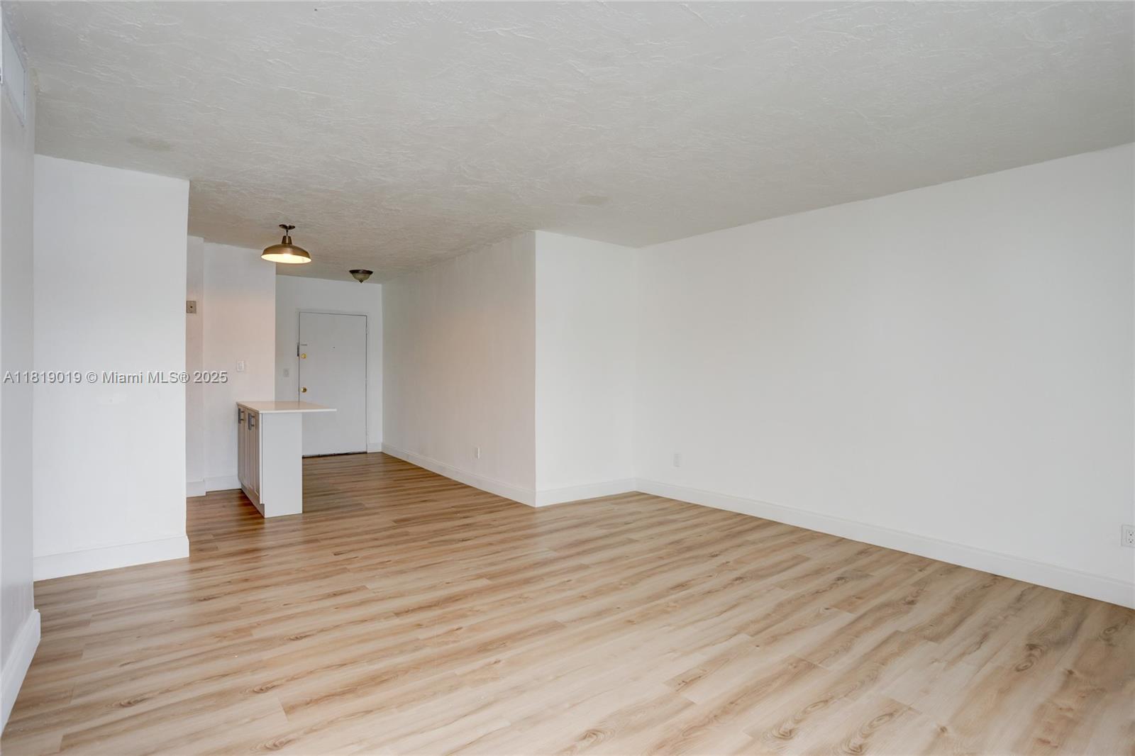 5501 Northwest 7th Street, Unit E408 Miami, FL 33126 - Photo 19 of 35 a view of an empty room and wooden floor
