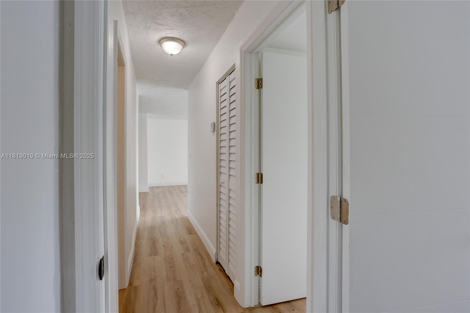 5501 Northwest 7th Street, Unit E408 Miami, FL 33126 - Photo 25 of 35 a view of a hallway with wooden floor
