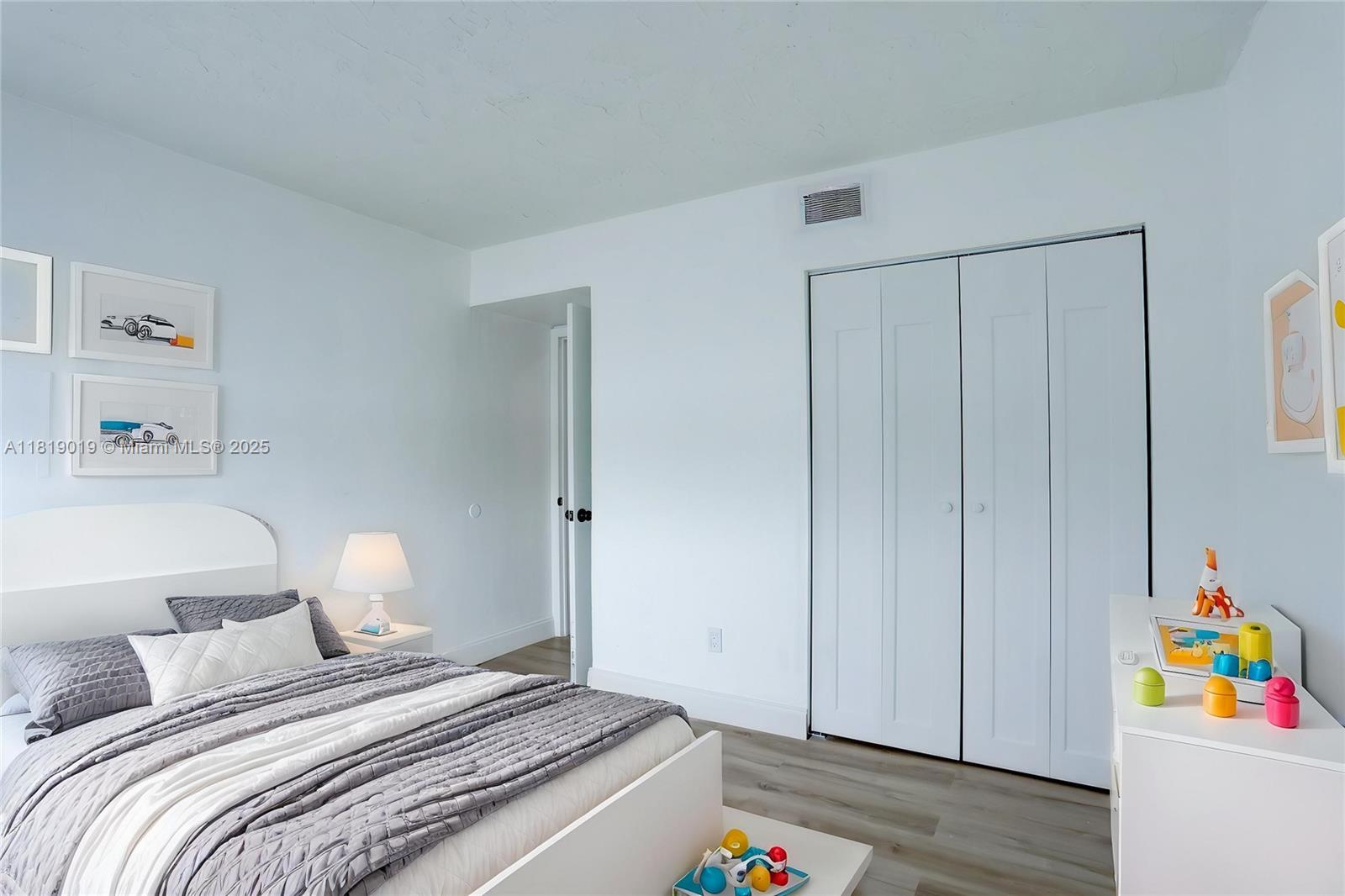 5501 Northwest 7th Street, Unit E408 Miami, FL 33126 - Photo 32 of 35 a bedroom with a bed and a window