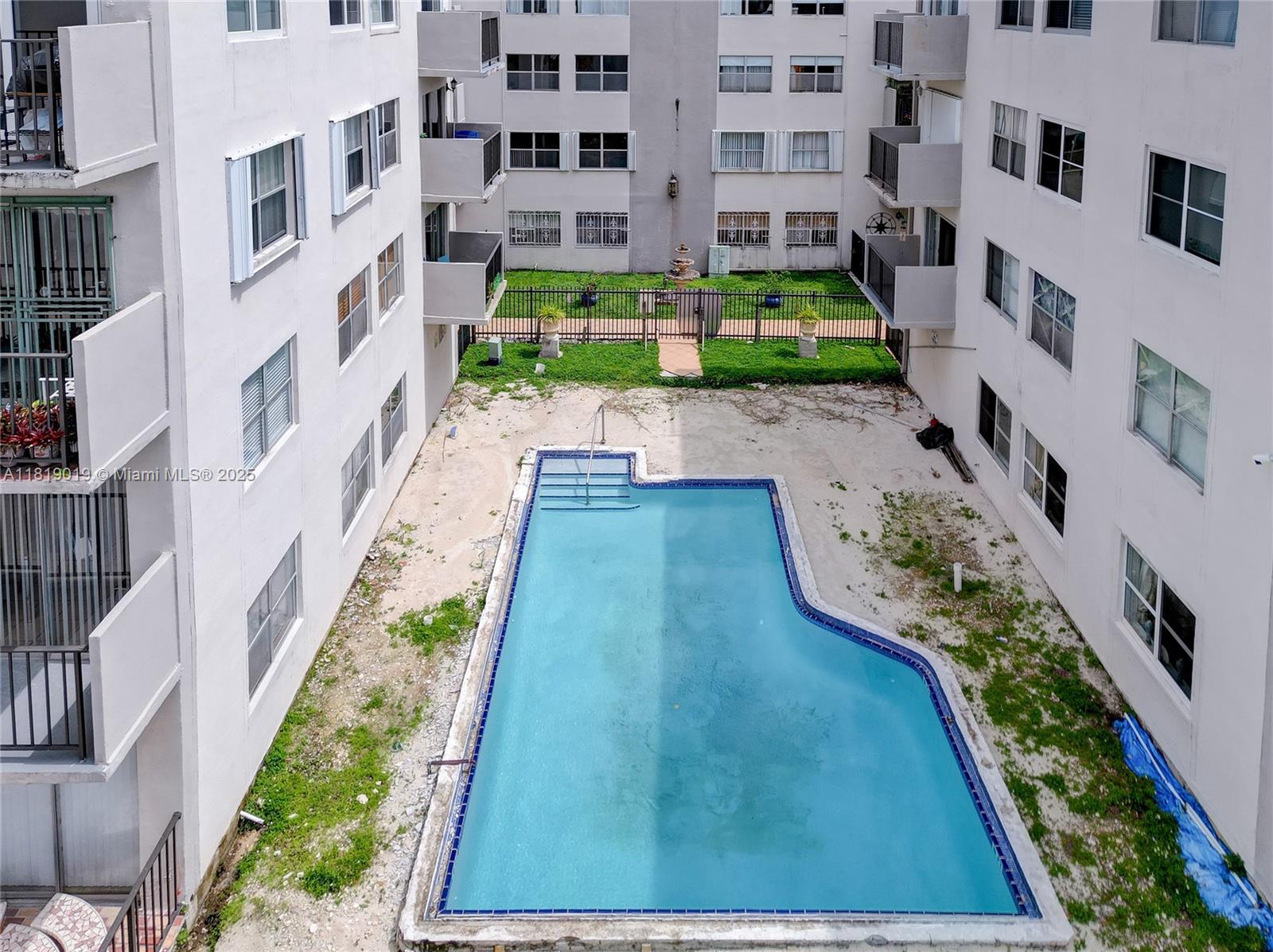 5501 Northwest 7th Street, Unit E408 Miami, FL 33126 - Photo 33 of 35 a view of a building with a yard