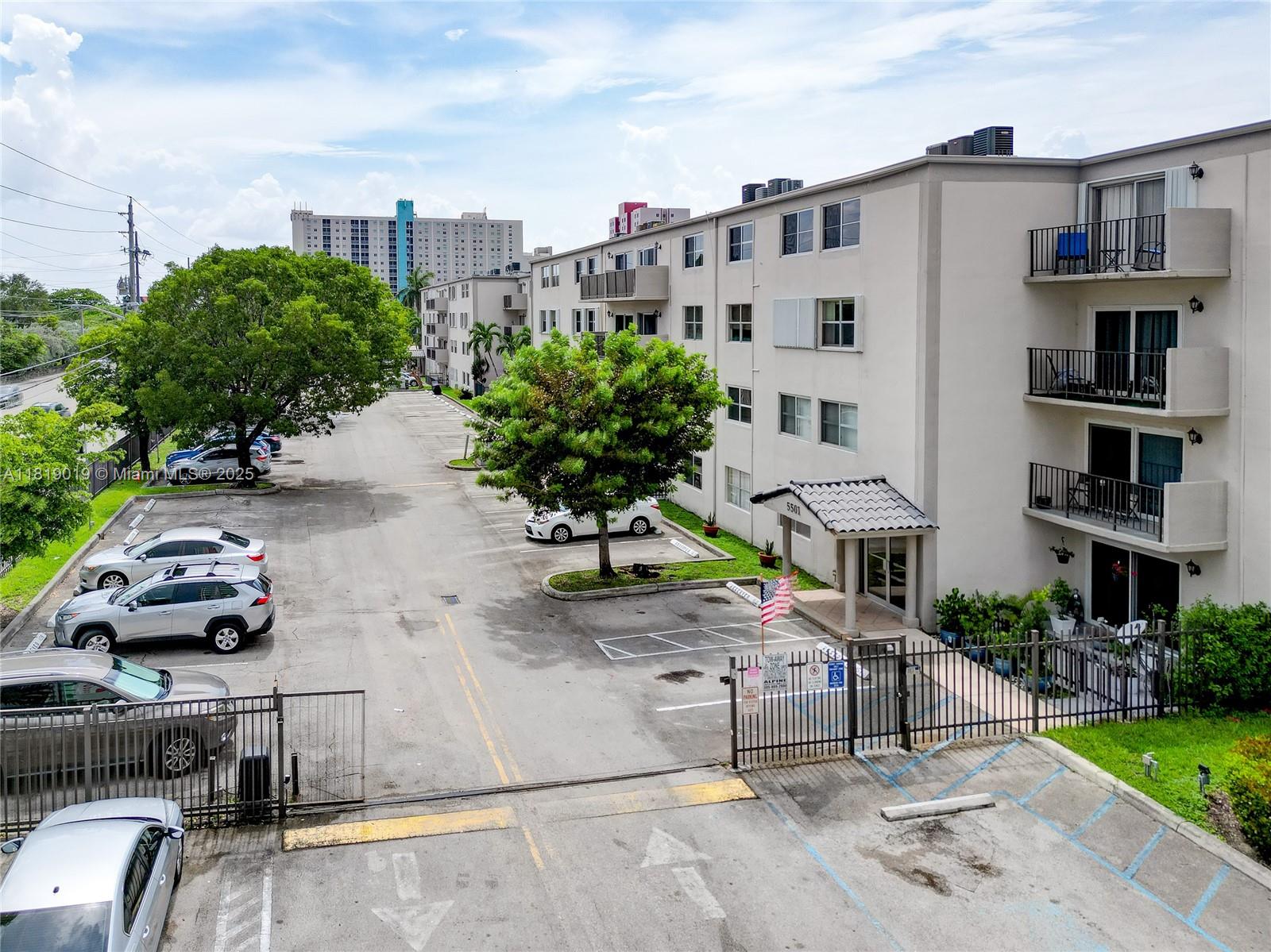 5501 Northwest 7th Street, Unit E408 Miami, FL 33126 - Photo 4 of 35 a front view of a building with garden