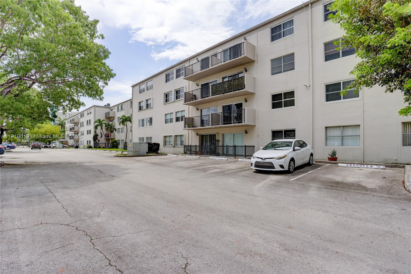 5501 Northwest 7th Street, Unit E408 Miami, FL 33126 - Photo 6 of 35 a car parked in front of a building
