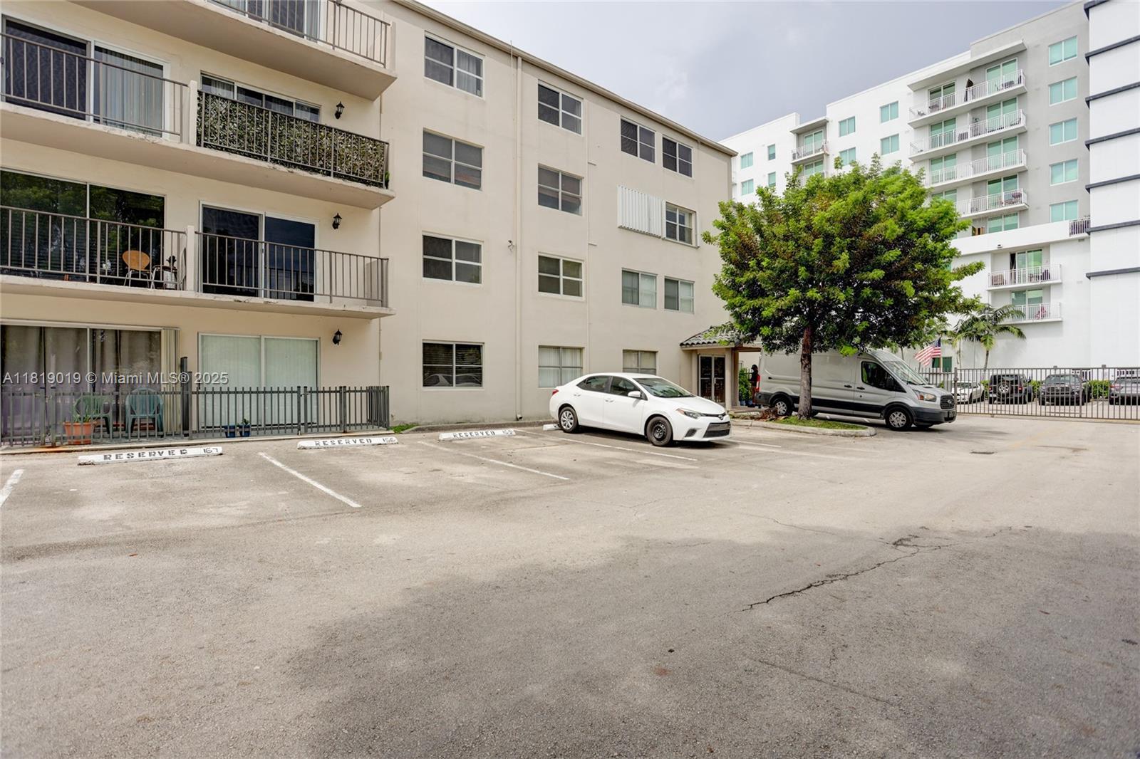 5501 Northwest 7th Street, Unit E408 Miami, FL 33126 - Photo 7 of 35 a car parked in front of a building