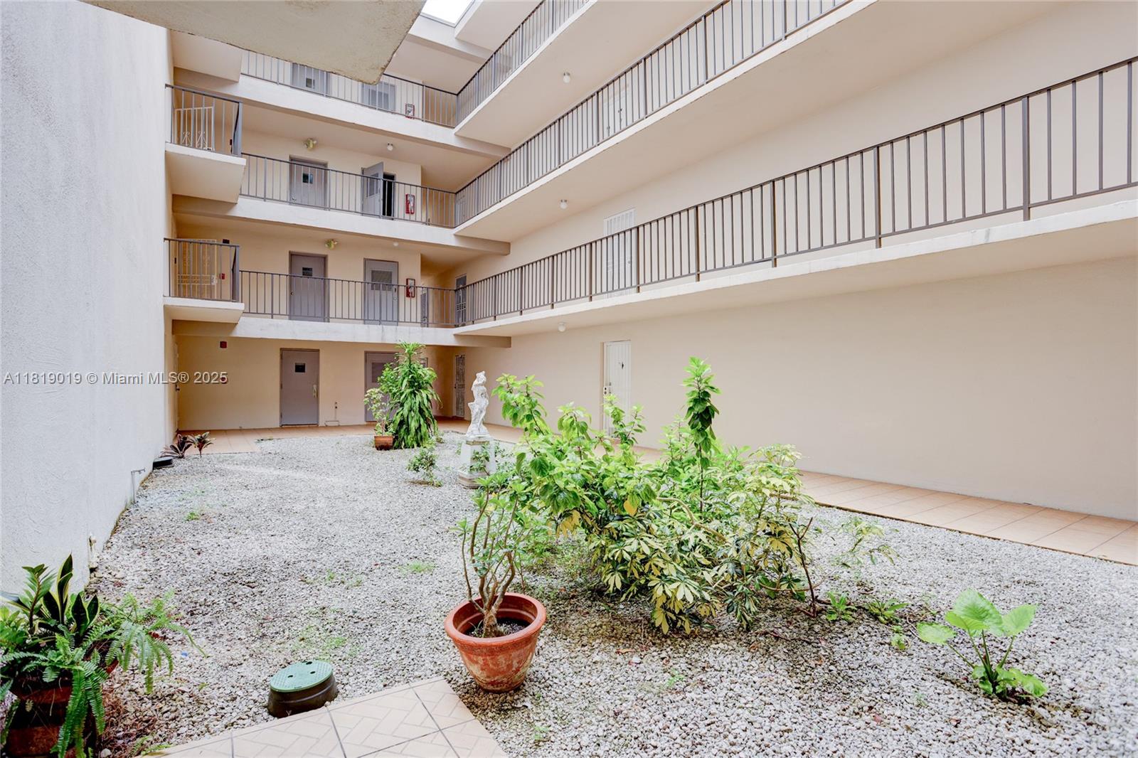 5501 Northwest 7th Street, Unit E408 Miami, FL 33126 - Photo 9 of 35 a view of outdoor space and yard