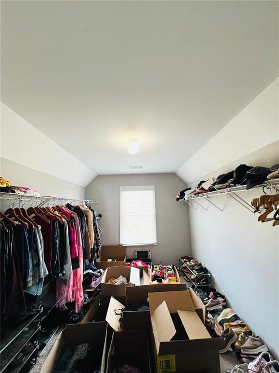 7437 Fireside Lane Flowery Branch, GA 30542 - Photo 12 of 16 a view of walk in closet with clothes and shoes