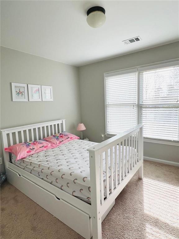 7437 Fireside Lane Flowery Branch, GA 30542 - Photo 13 of 16 a bedroom with a bed and a window