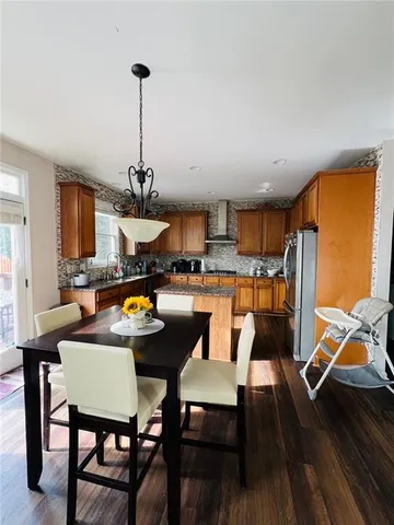 a kitchen with stainless steel appliances granite countertop a refrigerator a stove top oven a sink and dishwasher