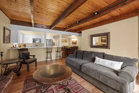 a living room with furniture and kitchen view