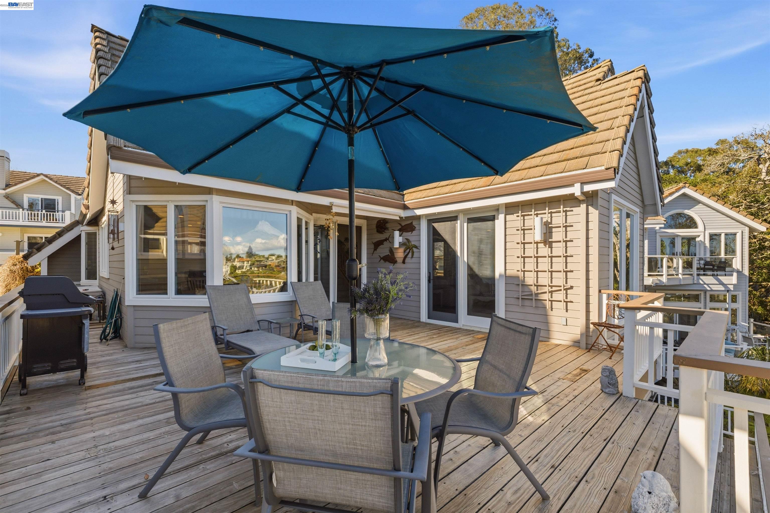 126 Frederick Street Santa Cruz, CA 95062 - Photo 28 of 60 a view of a patio with table and chairs under an umbrella