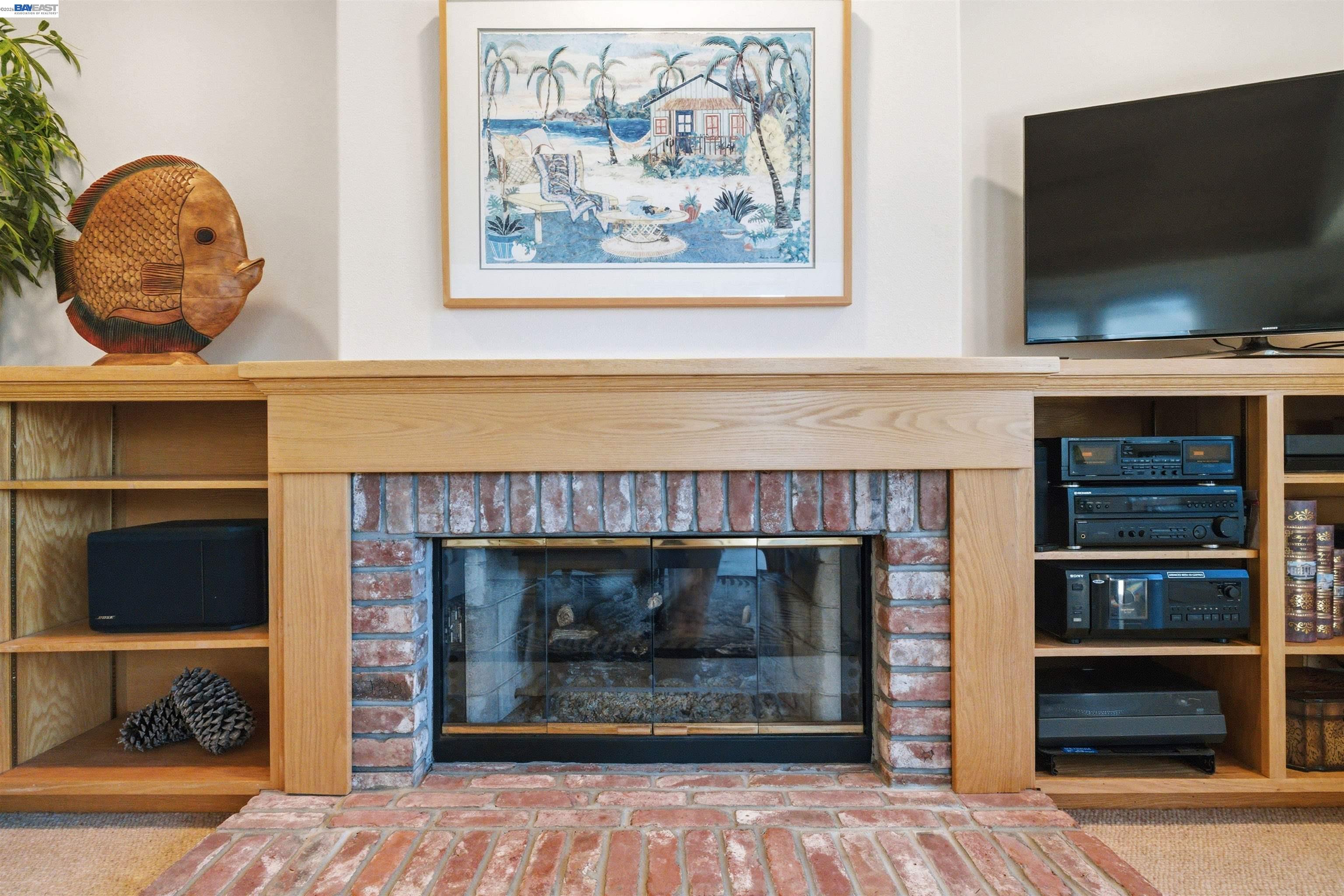 126 Frederick Street Santa Cruz, CA 95062 - Photo 6 of 60 a living room with a fireplace and a flat screen tv
