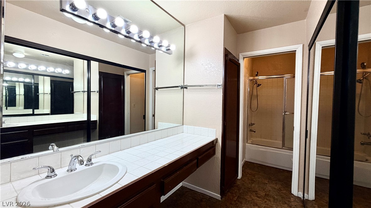 6250 West Flamingo Road, Unit 4 Las Vegas, NV 89103 - Photo 20 of 45 This bathroom features a sleek vanity and a shower-tub combination, providing comfort and convenience.