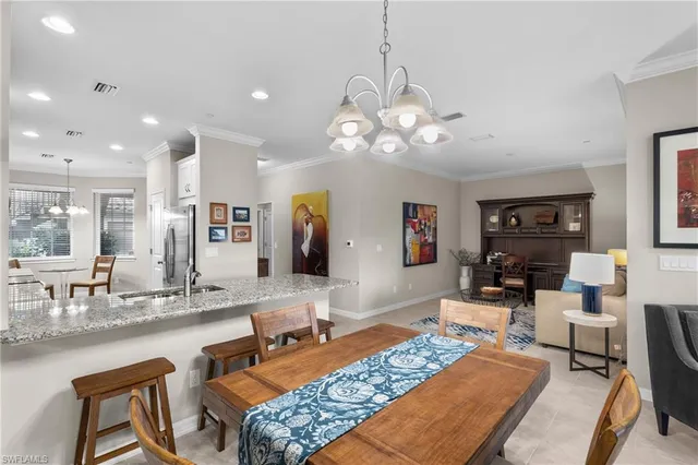 a living room with fireplace furniture and a chandelier