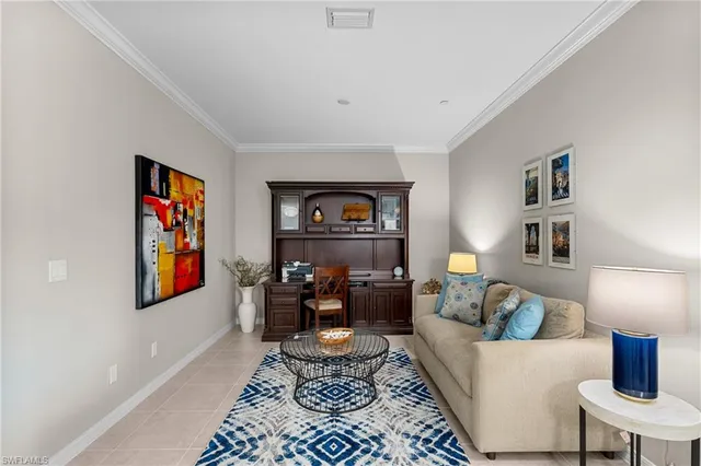 a living room with furniture and a lamp