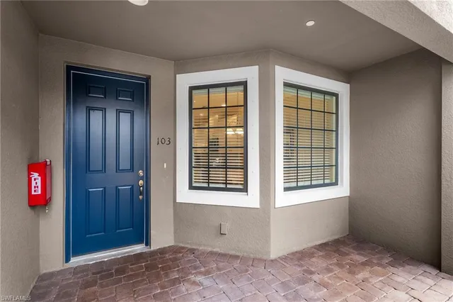 a view of an empty room with window and hallway