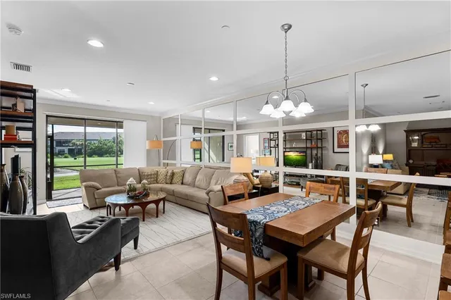 a dining room with furniture a chandelier and wooden floor