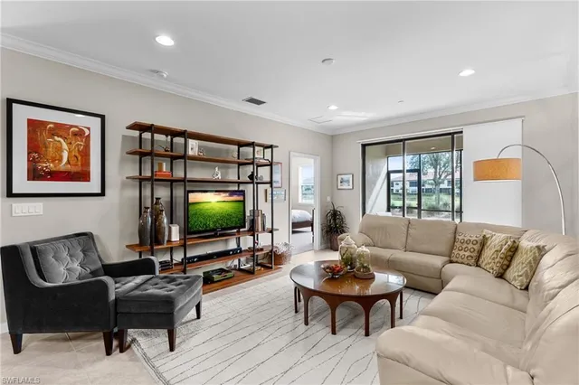 a living room with furniture a rug and a flat screen tv
