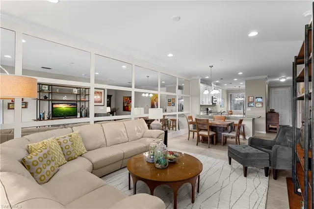 a living room with furniture kitchen view and a table