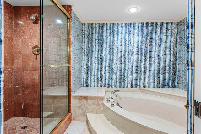 a bathroom with a bathtub and shower