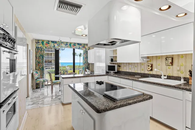 a kitchen with a stove a sink and a refrigerator