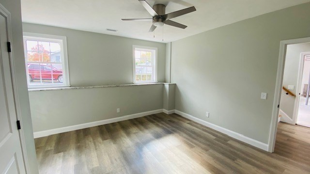 2 Touraine Street Worcester, MA 01604 - Photo 13 of 34 an empty room with wooden floor fan and windows