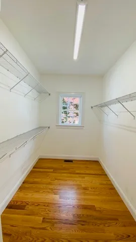 a bathroom with a granite countertop sink mirror vanity and a bathtub