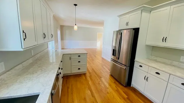 a bathroom with a granite countertop sink a toilet and a tub