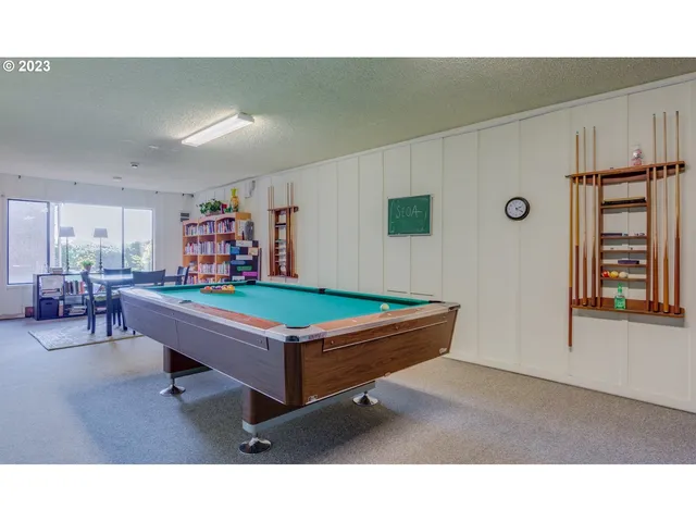 a room with furniture pool table and windows