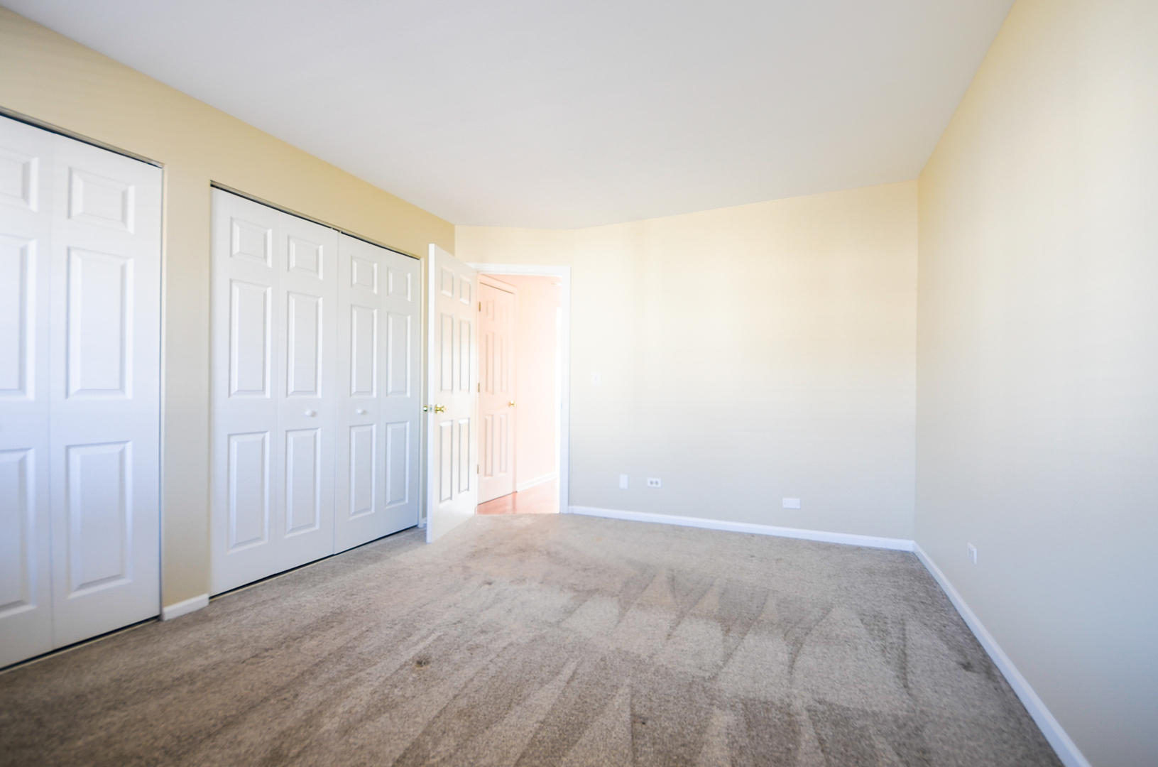 876 South Plum Grove Road, Unit 208 Palatine, IL 60067 - Photo 11 of 14 an empty room with wooden floor and windows