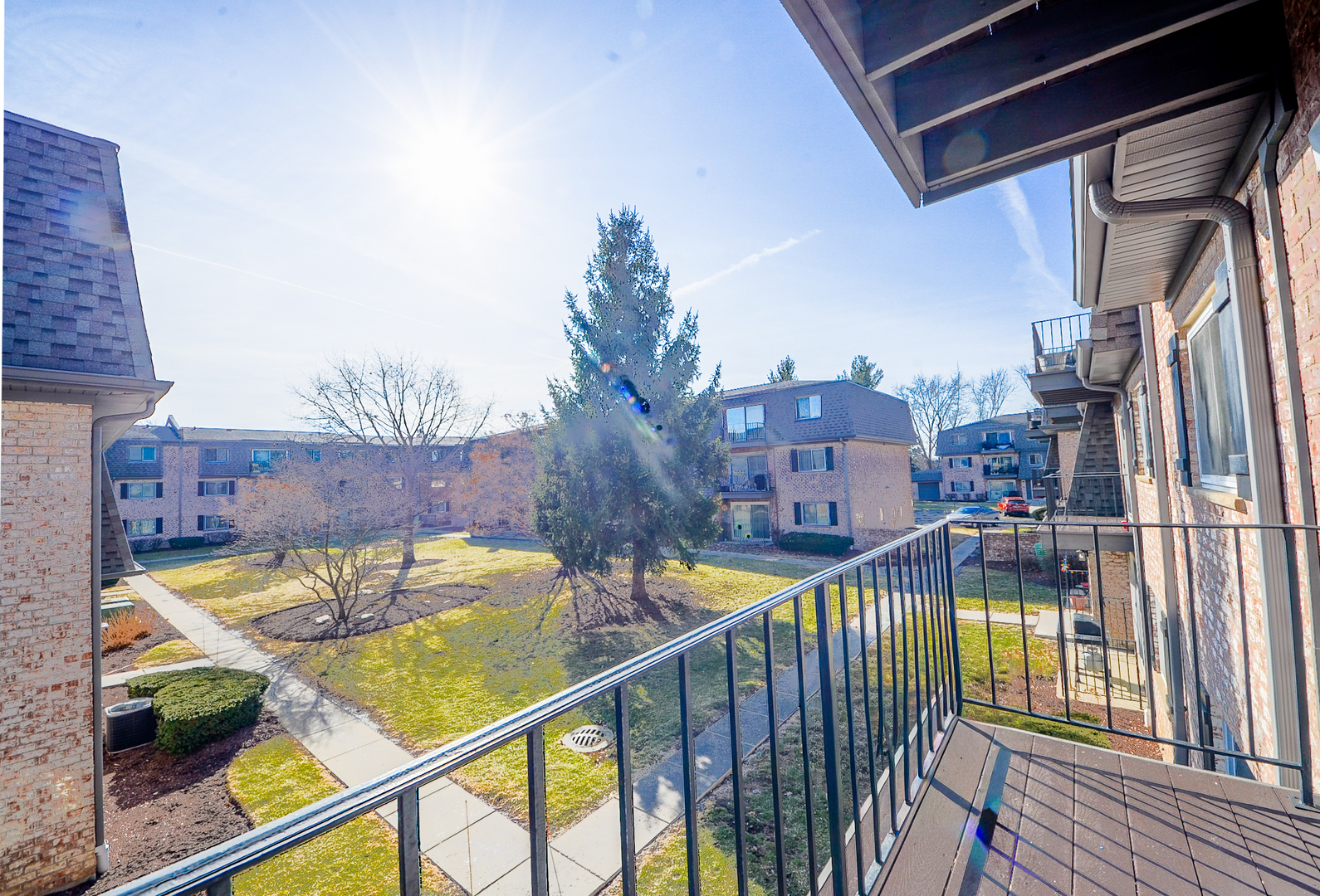 876 South Plum Grove Road, Unit 208 Palatine, IL 60067 - Photo 13 of 14 a view of a balcony with two couches and wooden floor