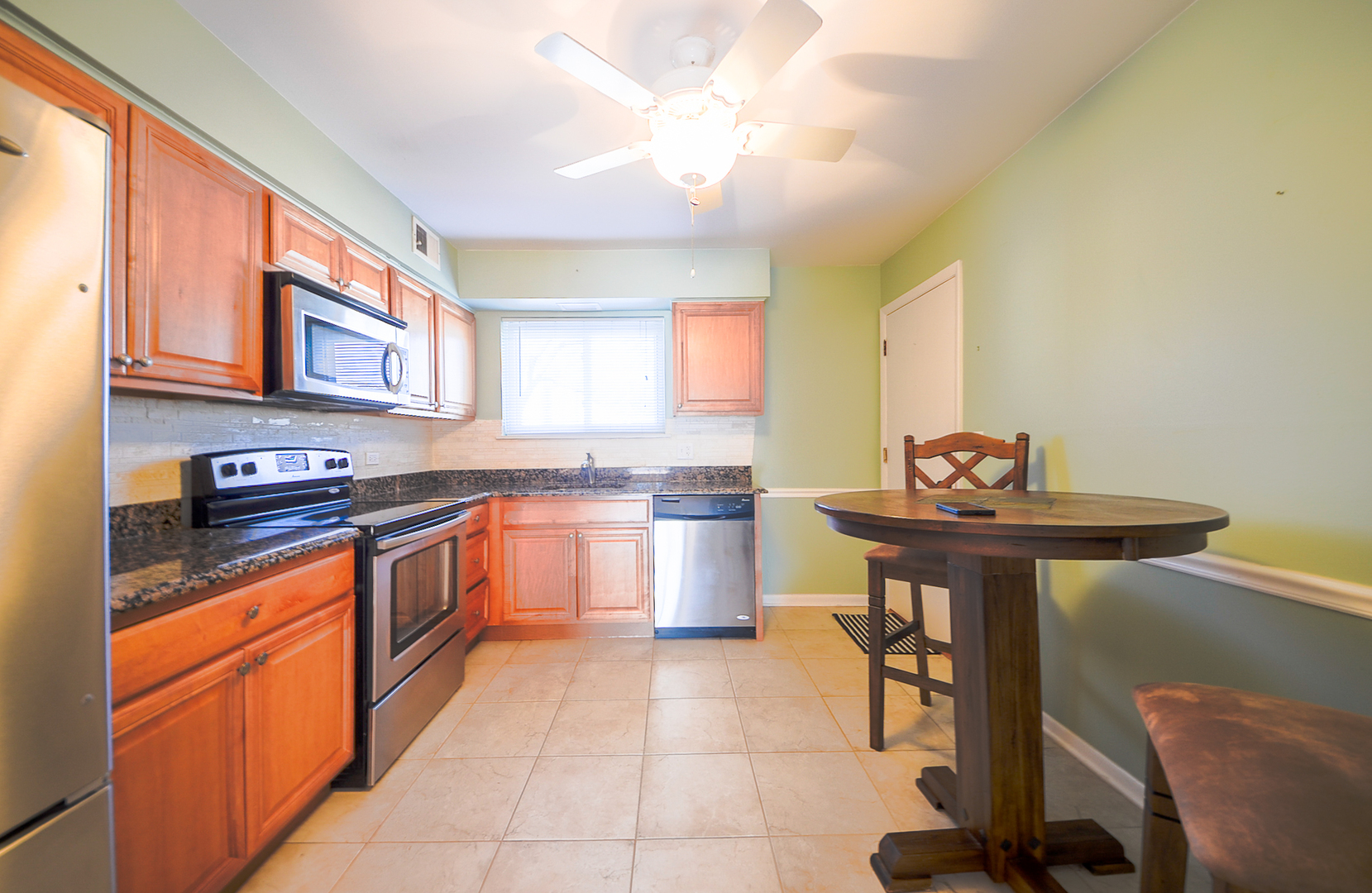 876 South Plum Grove Road, Unit 208 Palatine, IL 60067 - Photo 6 of 14 a kitchen with stainless steel appliances granite countertop a sink and cabinets
