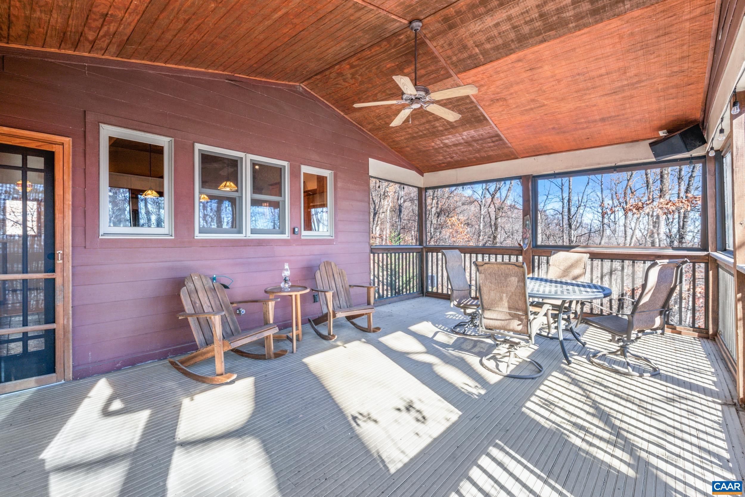 6696 Highlander Way Crozet, VA 22932 - Photo 27 of 71 a view of a patio with a dining table and chairs with wooden floor