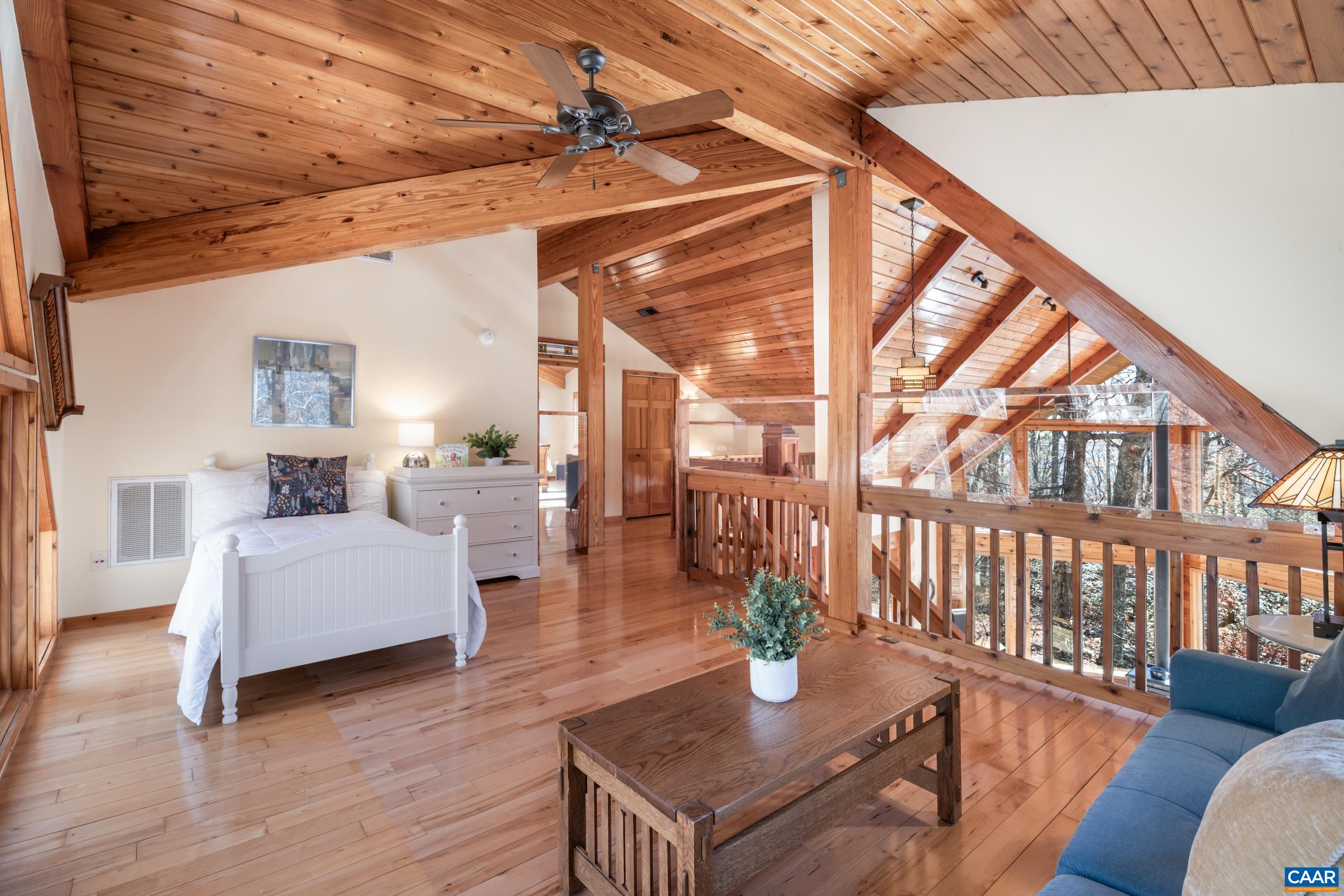 6696 Highlander Way Crozet, VA 22932 - Photo 32 of 71 a living room with furniture a wooden floor and a large window