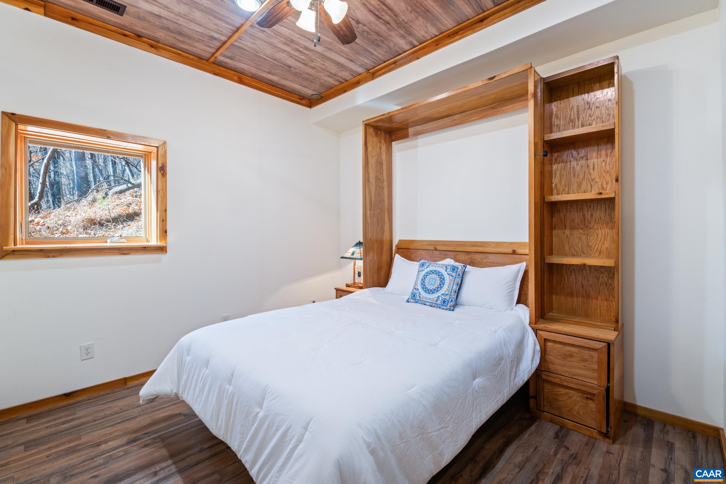 6696 Highlander Way Crozet, VA 22932 - Photo 47 of 71 a bedroom with a bed and a painting on the wall